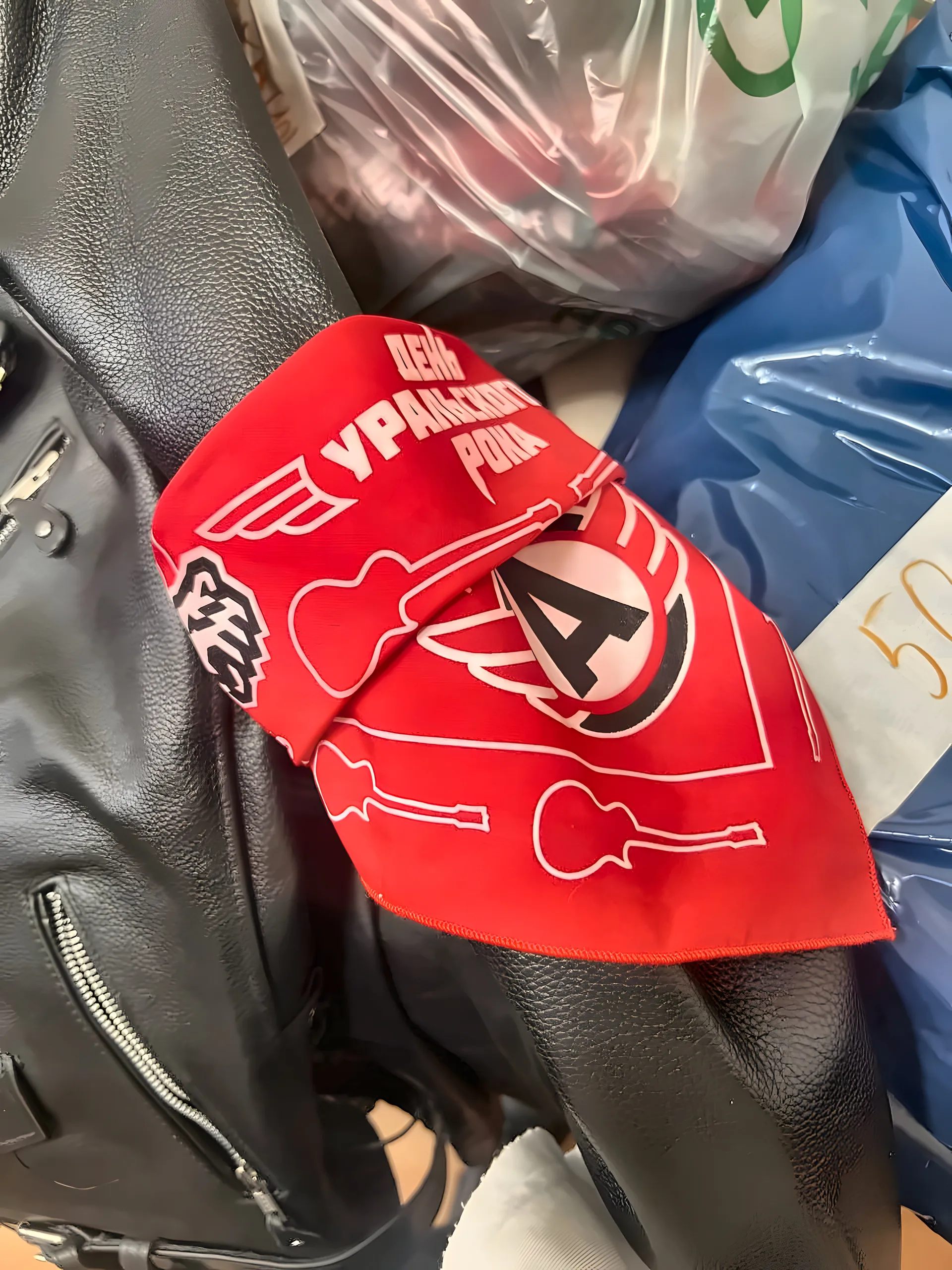 Red fan bandana printed with guitars and the club logo